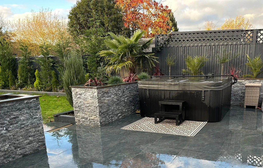 A hot tub incorporated into an outdoor paved entertainment area